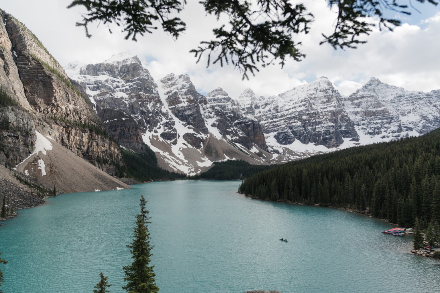 A high angle shot of a clear frozen lake surrounded by a mountainous scenery